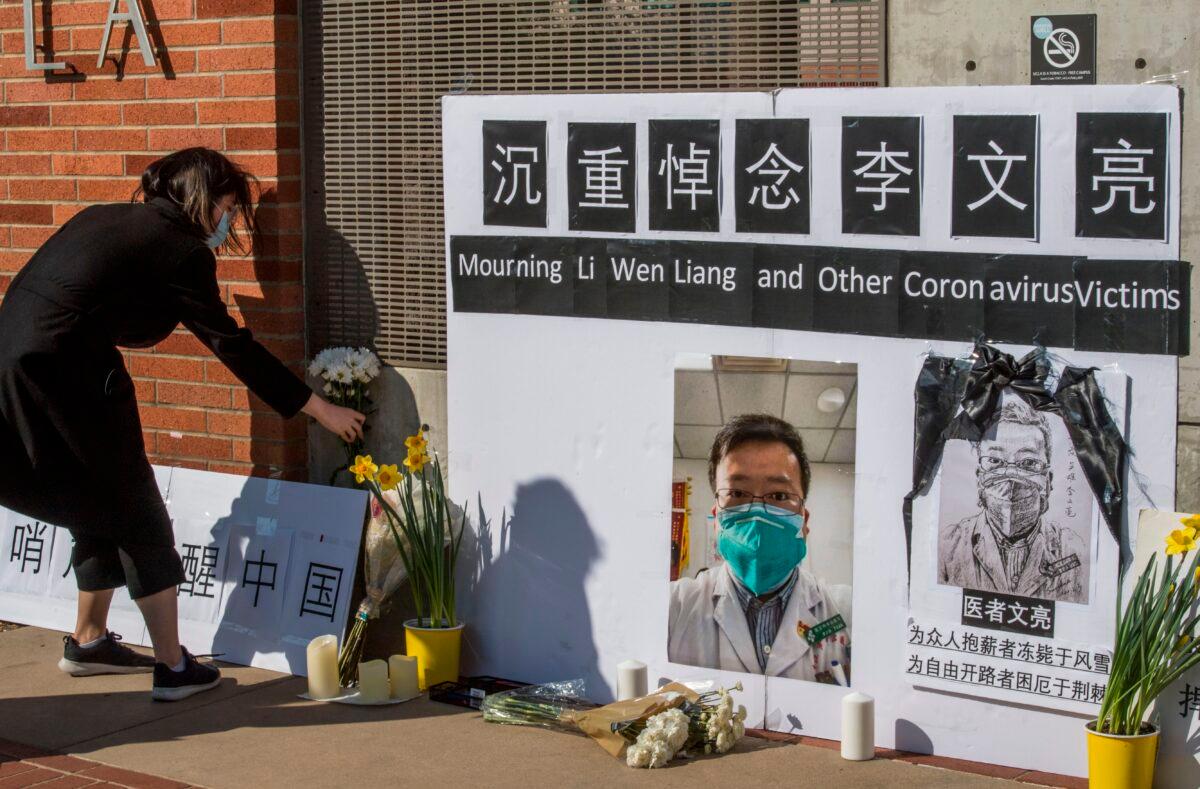Chinese students and their supporters hold a memorial for Dr. Li Wenliang, who was the whistleblower of COVID-19, which originated in Wuhan, China, and caused the doctor's death in that city, outside the UCLA campus in Westwood, Calif., on Feb. 15, 2020. (Mark Ralston /AFP via Getty Images)