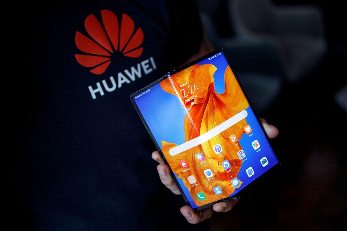 An employee displays the Huawei Mate Xs to media members during a video call for the launch of the foldable smartphone in London on Feb. 18, 2020. (Tolga Akmen/AFP via Getty Images)