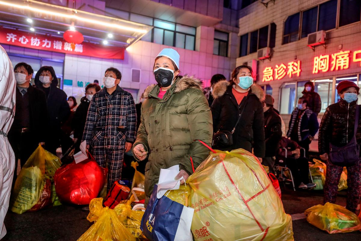 Patients infected by the COVID-19 coronavirus wait to be transferred from Wuhan No.5 Hospital to Leishenshan Hospital, the newly-built hospital for the COVID-19 coronavirus patients in Wuhan, China on March 3, 2020. (STR/AFP via Getty Images)