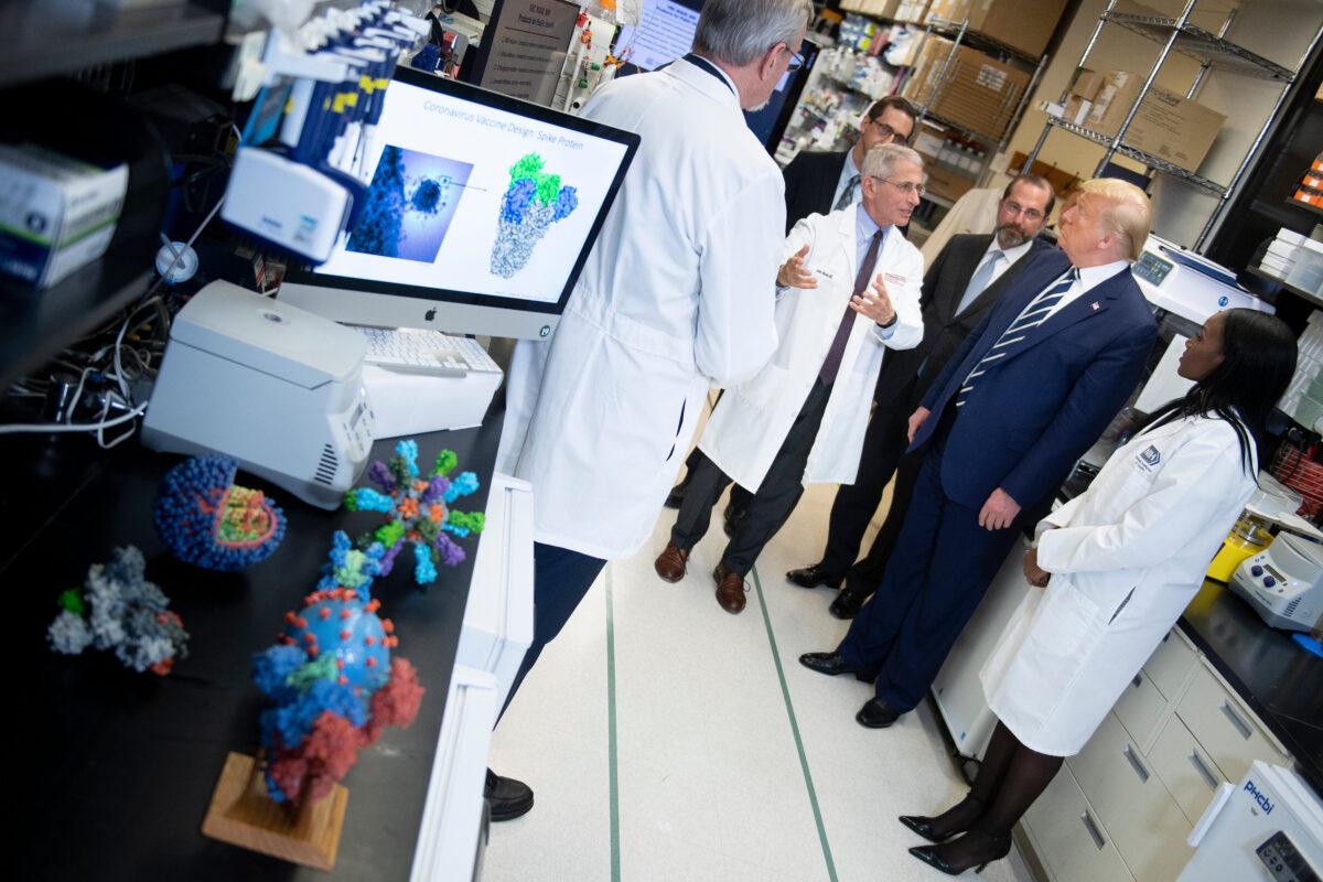 National Institute of Allergy and Infectious Diseases Director Dr. Anthony Fauci speaks to President Donald Trump during a tour of the National Institutes of Health's Vaccine Research Center in Bethesda, Maryland, on March 3, 2020. (Brendan Smialowski/AFP via Getty Images)