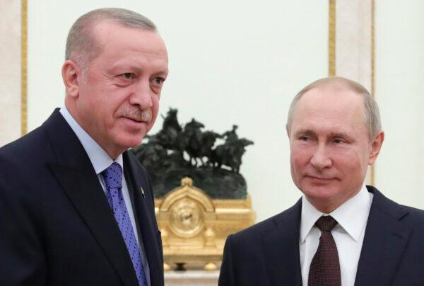 Russian President Vladimir Putin (R) and Turkish President Recep Tayyip Erdogan pose during their meeting in the Kremlin, in Moscow, Russia, on March 5, 2020. (Mikhail Klimentyev/ Sputnik/Kremlin Pool Photo via AP)