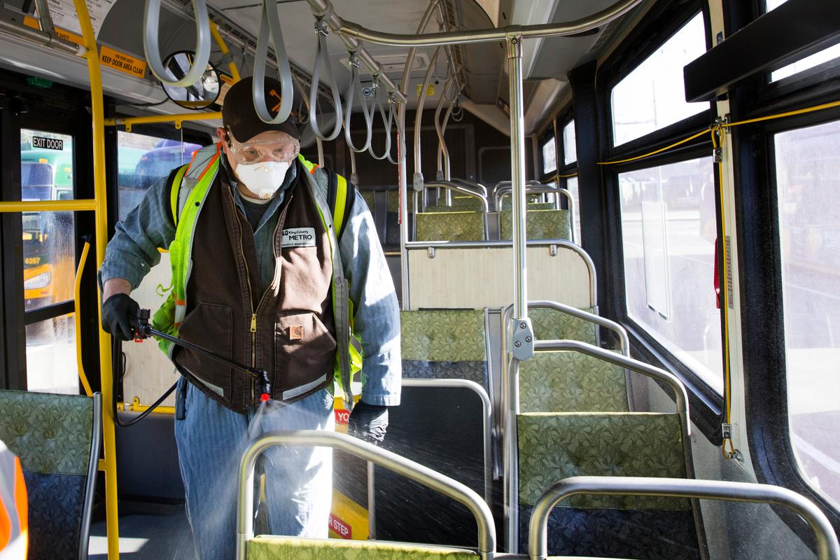 A King County Metro worker sprays a disinfectant on a metro bus in Seattle, Washington, on March 4, 2020. (Karen Ducey/Getty Images)