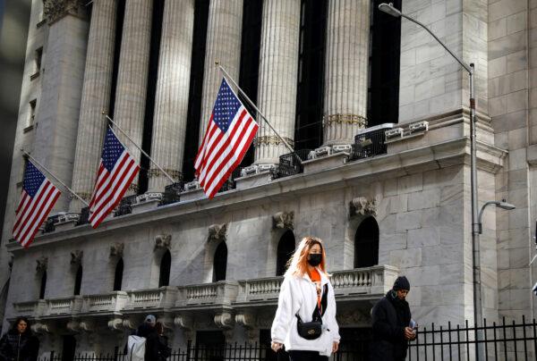 A woman wears a mask near the New York Stock Exchange (NYSE) in the Financial District in New York, on March 4, 2020. (Reuters/Brendan McDermid)