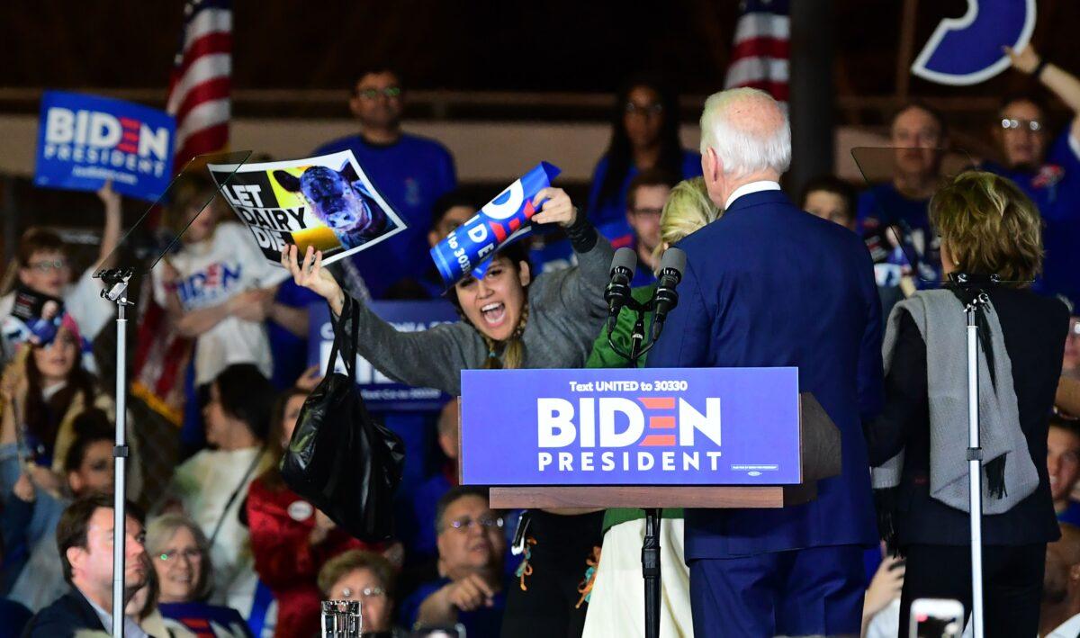 Democratic presidential hopeful former Vice President Joe Biden and his wife Jill watch as a protester is tackled at a rally in Los Angeles on March 3, 2020. (Frederic J. Brown/AFP via Getty Images)