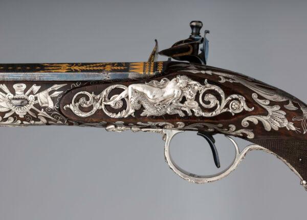 Many of the ornamental motifs on this flintlock pistol are taken from ancient Rome. Here, a nereid (sea nymph) feeds a sea leopard; 1800–1801, by gunmaker Samuel Brunn and silversmith Michael Barnett. British, London. Purchased through the Harris Brisbane Dick Fund and gift of George D. Pratt, by exchange, 1992. (The Metropolitan Museum of Art)