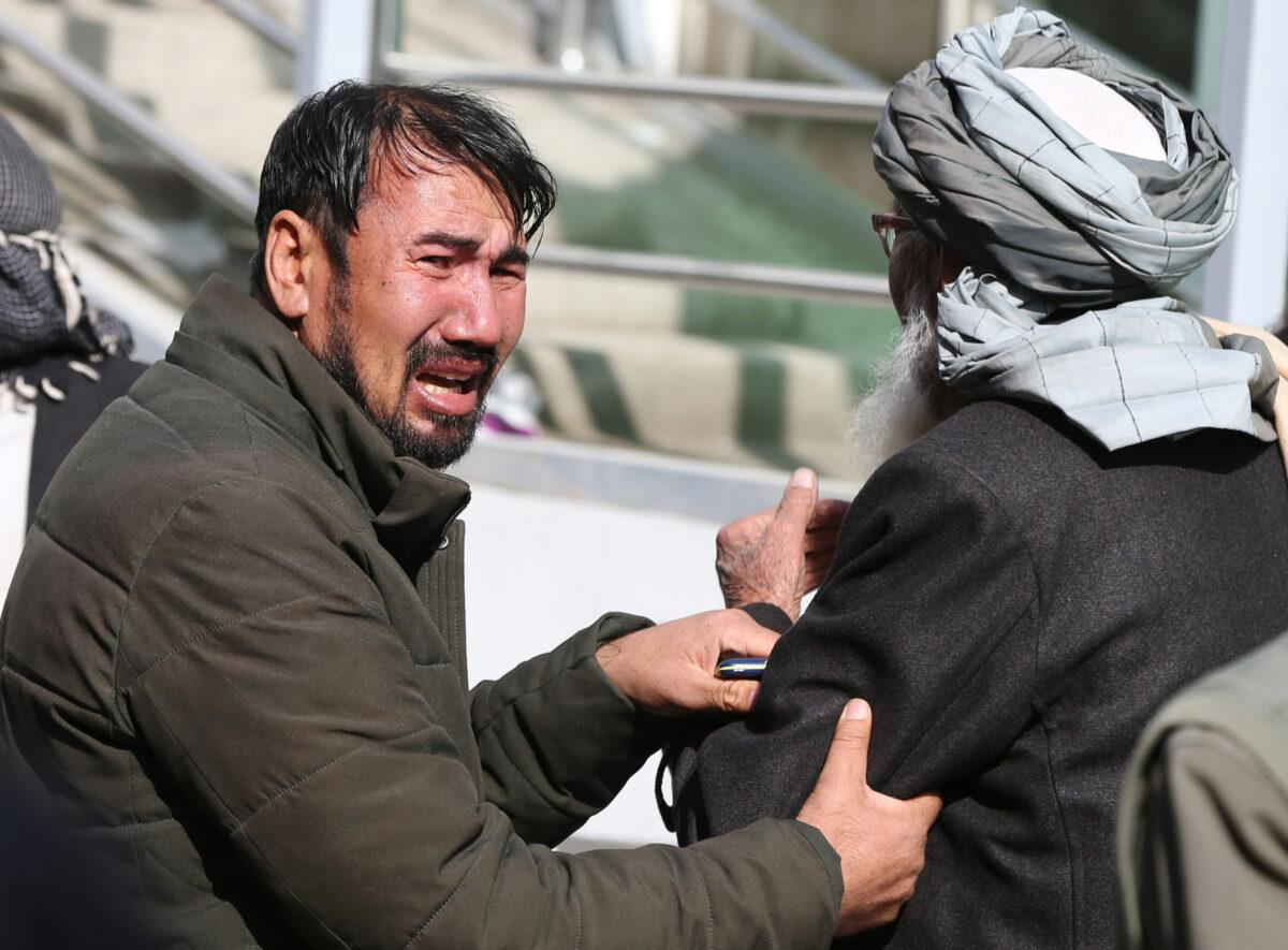 Afghan men cry at a hospital after they heard that their relative was killed during an attack in Kabul, Afghanistan, on March 6, 2020. (Omar Sobhani/Reuters)