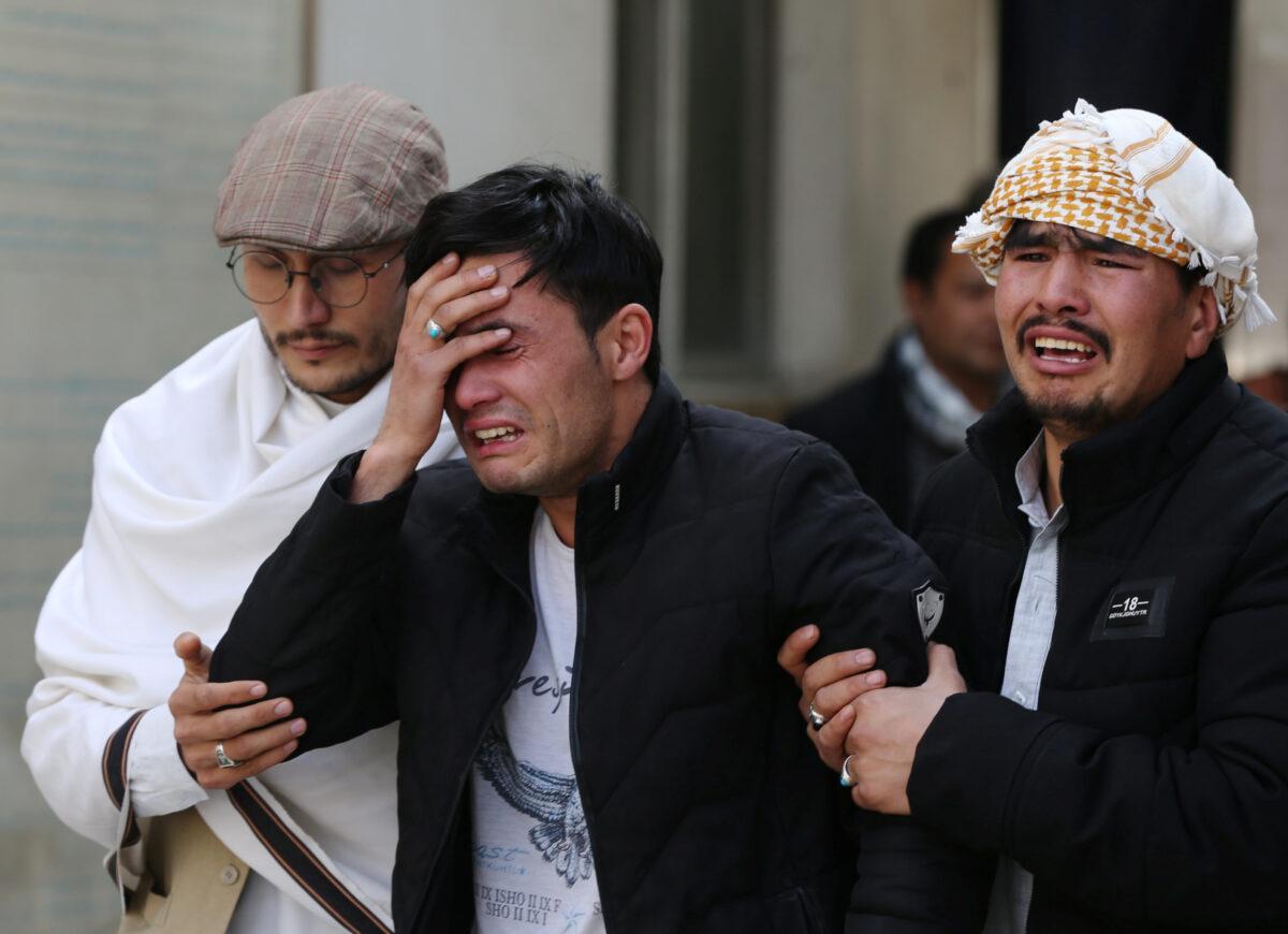 Afghan men cry at a hospital after they heard that their relative was killed during an attack in Kabul, Afghanistan, on March 6, 2020. (Omar Sobhani/Reuters)