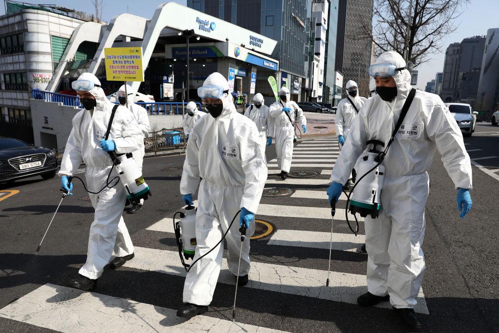 South Korean soldiers wearing protective gear, spray antiseptic solution against the novel coronavirus in Gangnam district in Seoul, South Korea, on March 6, 2020. (Chung Sung-Jun/Getty Images)