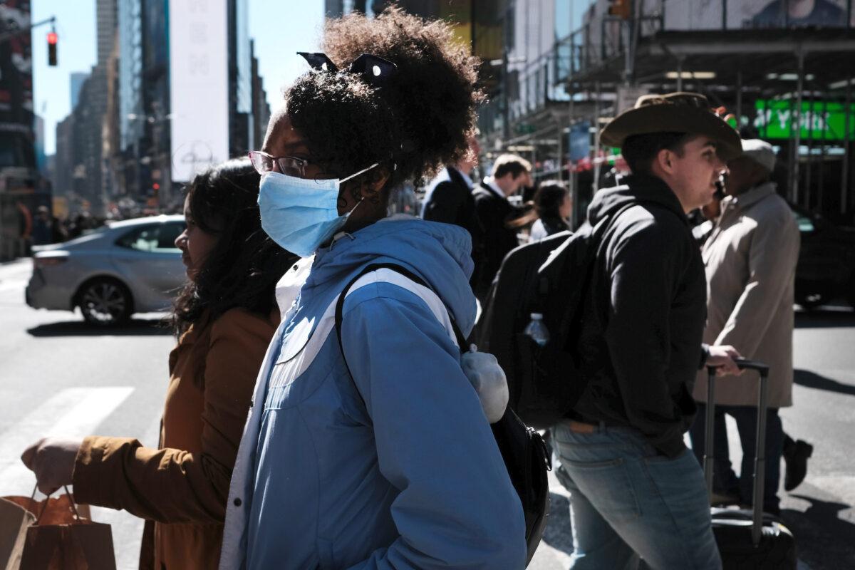 People walk through Manhattan with surgical masks in New York City, on March 4, 2020. (Spencer Platt/Getty Images)
