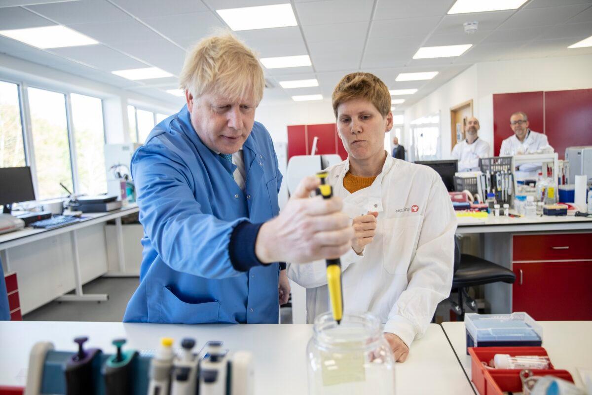 Britain's Prime Minister Boris Johnson visits the Mologic Laboratory in the Bedford technology Park, England, on March 6, 2020. (Jack Hill/Pool via AP)