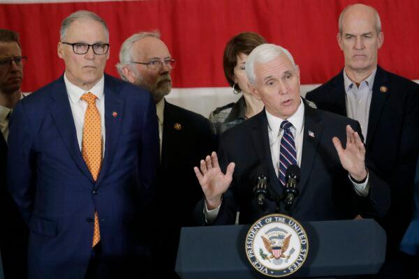 Vice President Mike Pence, at podium, speaks as Gov. Jay Inslee, left, and other officials look on during a news conference at Camp Murray in Washington state on March 5, 2020. Pence was in Washington to discuss the state's efforts to fight the spread of the COVID-19 coronavirus. (Ted S. Warren/AP Photo)