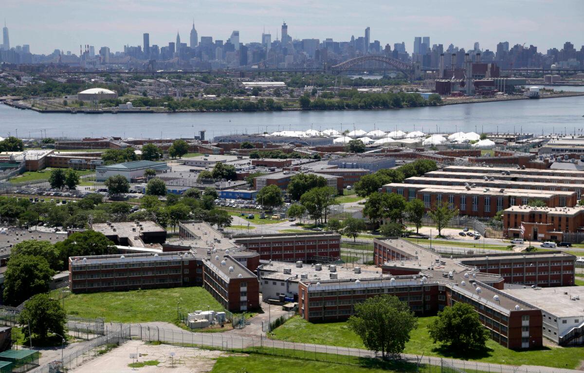 The Rikers Island jail complex stands in New York with the Manhattan skyline in the background. The nation’s jails and prisons are on high alert about the prospect of the new coronavirus spreading through their vast inmate populations on June 20, 2014. (Seth Wenig/AP Photo)