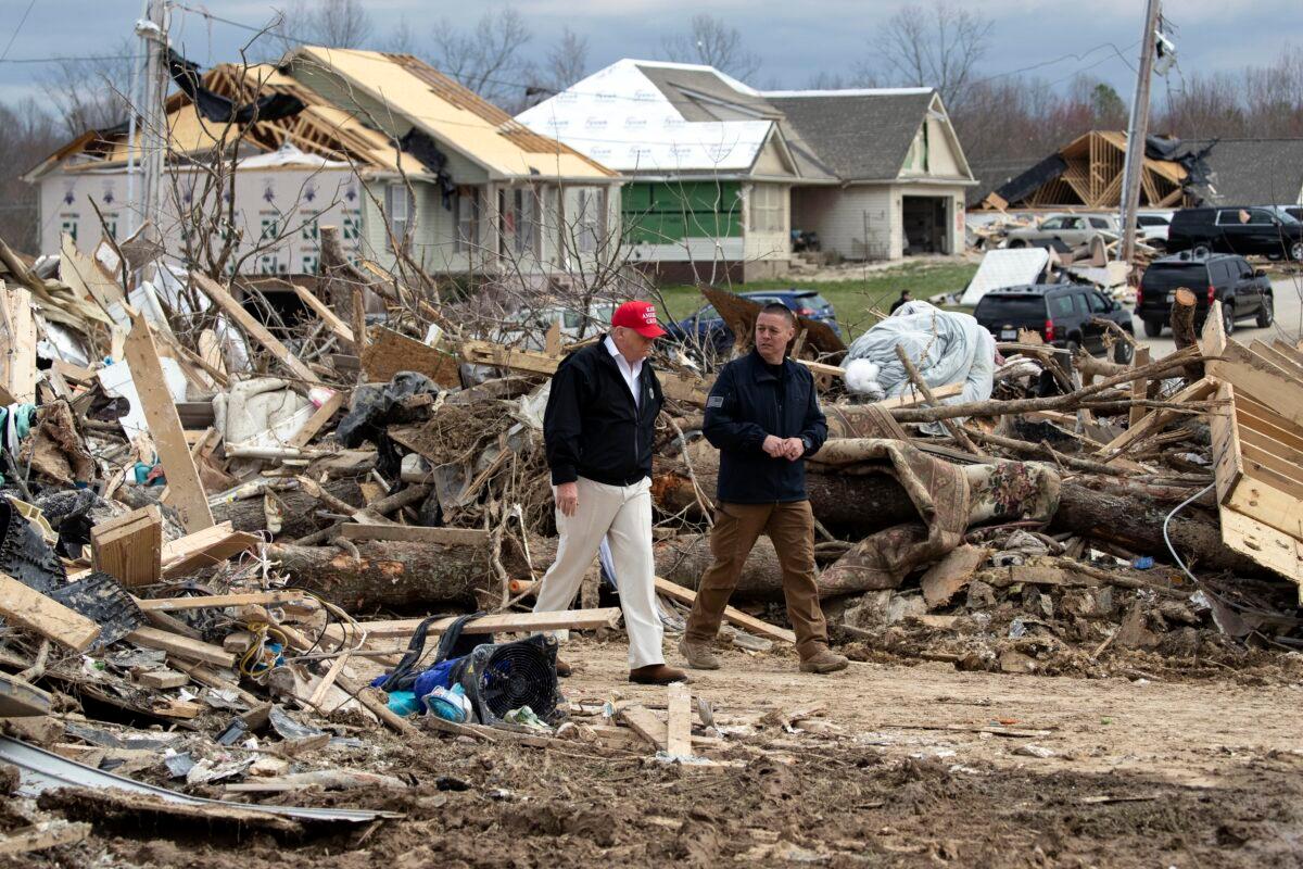 President Donald Trump speaks Mike Herrick, with Putnam County Rescue Squad, as he tours damage from a recent tornado in Cookeville, Tenn., on March 6, 2020. (Alex Brandon/AP Photo)