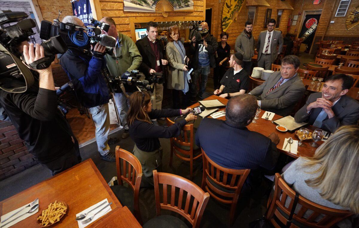 Westchester County Executive George Latimer (C) and New Rochelle Mayor Noam Bramson (R) are surrounded by the press as they have lunch at Eden Wok Kosher Chinese in the New Rochelle Wykagyl area of New Rochelle, New York on March 5, 2020. (Timothy A. Clary/AFP via Getty Images)