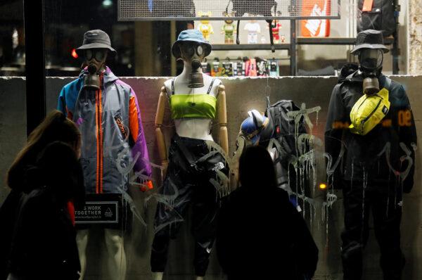 Mannequins wearing protective masks stand in a shop display window after a government decree to close schools, cinemas and theatres, and recommending that people do not shake hands or hug each other and that they maintain a distance of at least one metre, in Rome, Italy, on March 6, 2020. (Remo Casilli/Reuters)