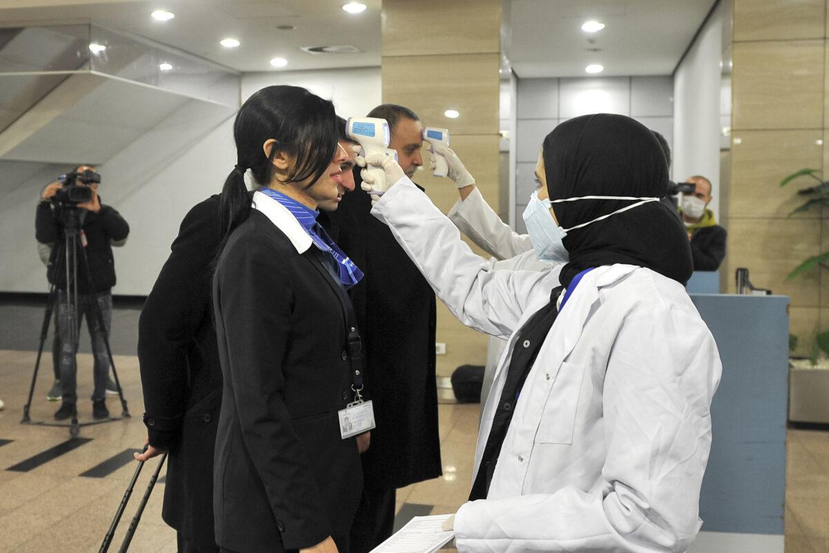 Egyptian health workers scan people's body temperatures at Cairo International Airport on Feb. 1, 2020. (AFP via Getty Images)