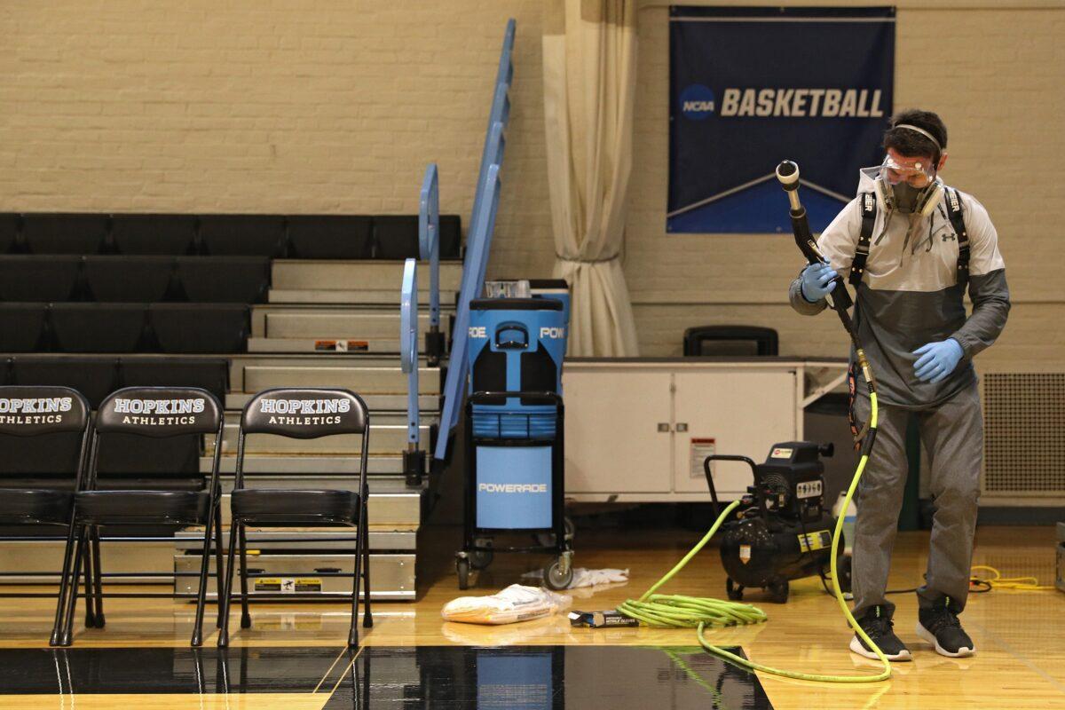 Taylor Michel, Director of Operations of Disinfecting Technologies Group, prepares to disinfect the arena following Yeshiva playing Worcester Polytechnic Institute at Johns Hopkins University in Baltimore, Maryland, on March 6, 2020. (Patrick Smith/Getty Images)