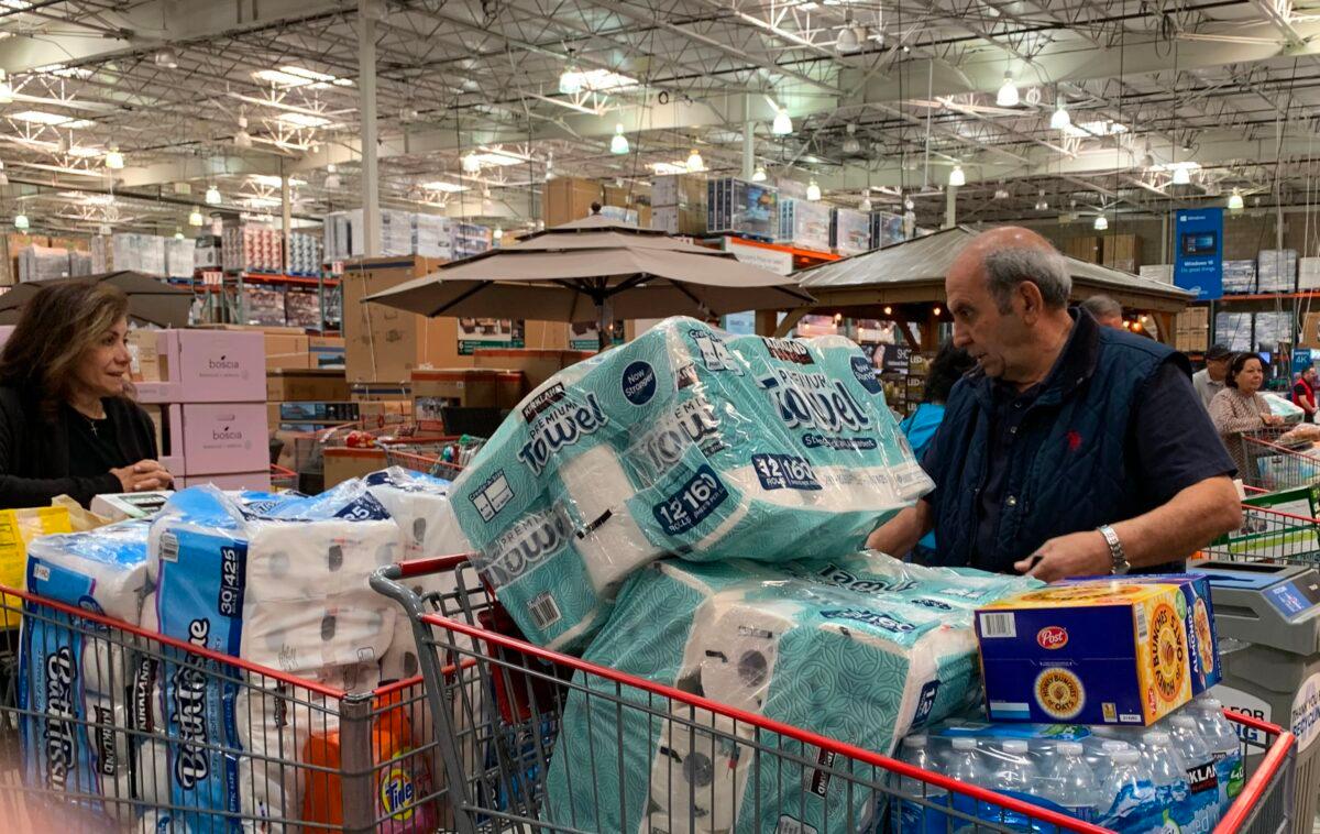 Customers wait in line to buy water and other supplies, on fears that the coronavirus, COVID-19, will spread and force people to stay indoors, at a Costco in Burbank, California on March 6, 2020. (Robyn Beck/AFP via Getty Images)