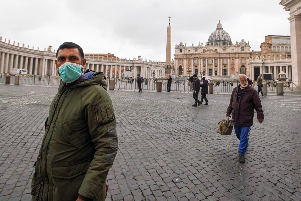 A man wearing a mask walks in St. Peter's Square at the Vatican on March 6, 2020. (Andrew Medichini/AP Photo)