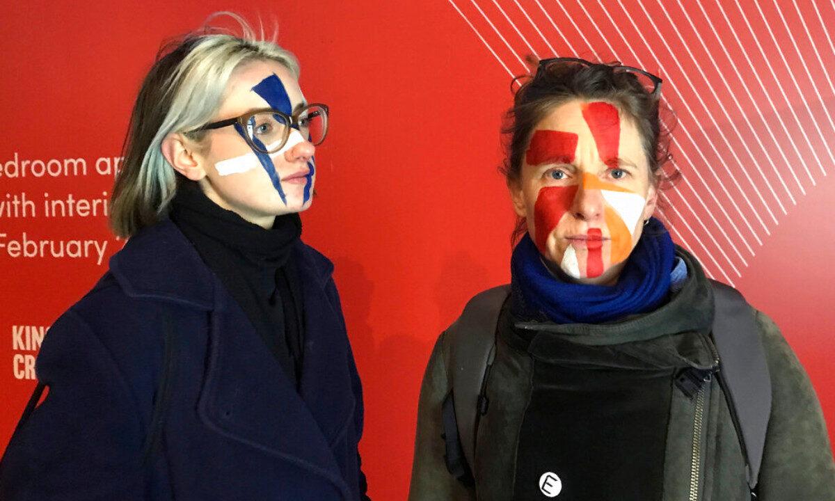 Artists Georgina Rowlands (L) and Anna Hart pose for a photo with their faces painted on Feb. 17, 2020. (Kelvin Chan/AP Photo)