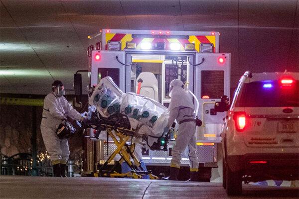 A woman who tested positive with the coronavirus is brought to the University of Nebraska Medical Center. (Chris Machian, Omaha World-Herald / The Associated Press)