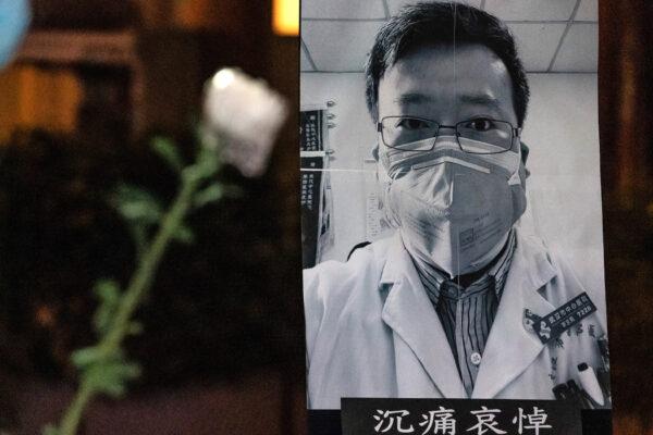 People attend a vigil to mourn for doctor Li Wenliang in Hong Kong, on Feb. 7, 2020. Li was one of eight doctors punished by Chinese police for informing the public about the early outbreak of the CCP virus. (Anthony Kwan/Getty Images)