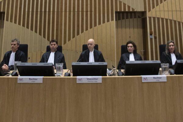 Presiding Judge Hendrik Steenhuis, center, judges Dagmar Koster, second left, Heleen Kerstens-Fockens, second right, Daan Glass, left, and Edith Poppe-Gielesen, right, are seen at the start of the trial of four men charged with murder over the downing of Malaysia Airlines Flight 17, at Schiphol airport, near Amsterdam, on March 9, 2020. (Peter Dejong/AP Photo)