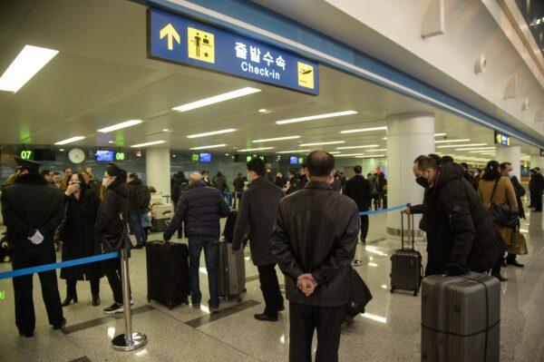 Foreign diplomats, embassy staff, and their families check-in for a flight to Vladivostok at Pyongyang International Airport on March 9, 2020. (Kim Won Jin/AFP/Getty Images)