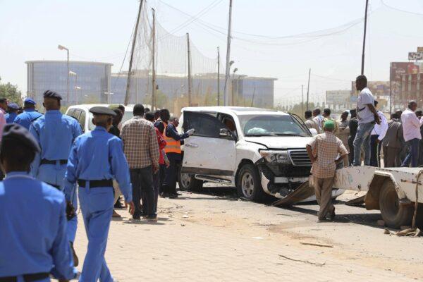 Sudanese policemen stand around vehicles that were part of Prime Mister Abdalla Hamdok's motorcade in Khartoum, Sudan, on March 9, 2020. (Marwan Ali/AP Photo)