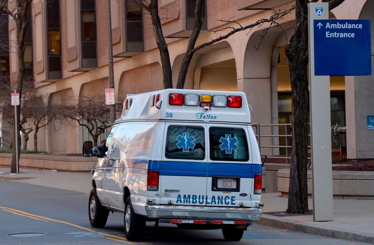 An ambulance drives by Brigham and Women's Hospital, which was testing dozens of people who attended the February Biogen conference in Boston, on March 7, 2020. (Joseph Prezioso/AFP via Getty Images)