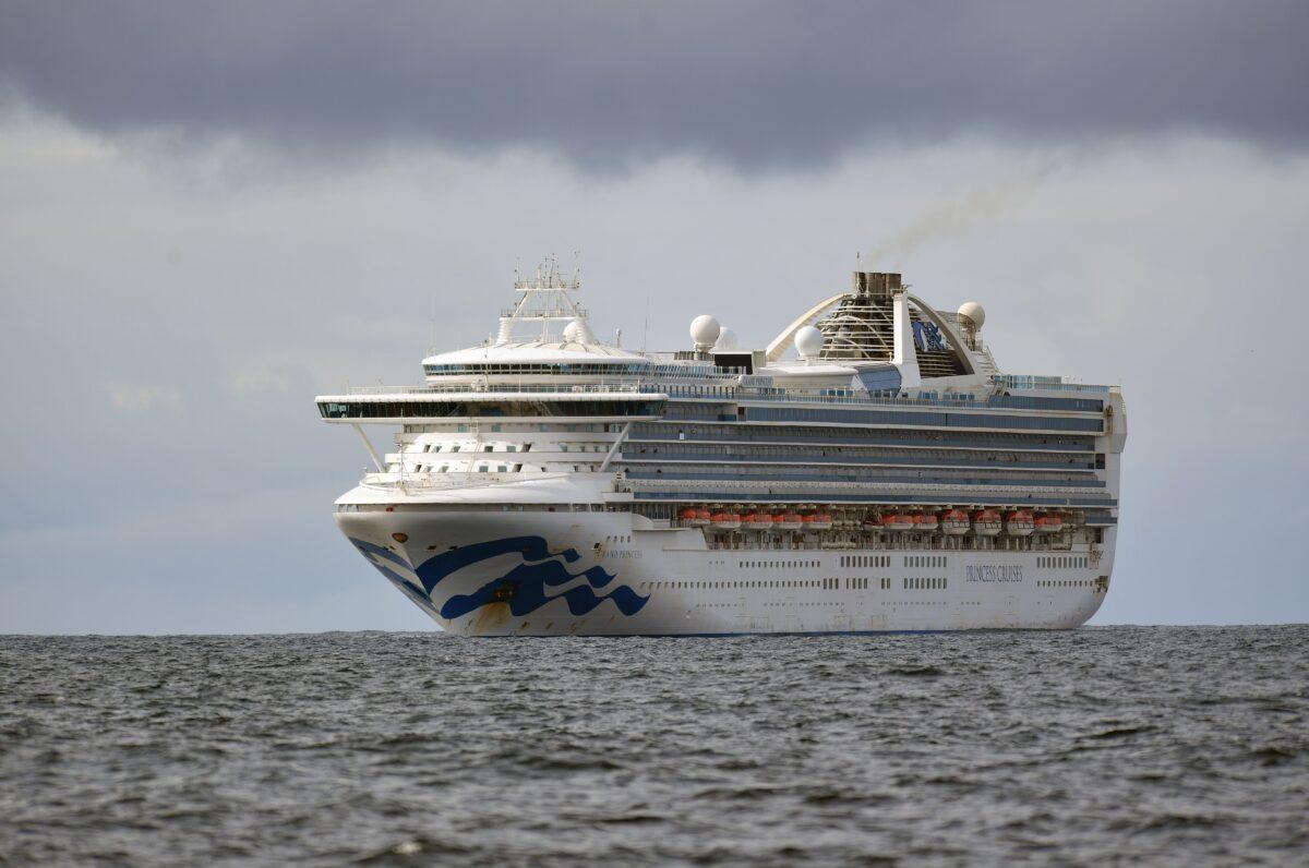 People look out from aboard the Grand Princess cruise ship, operated by Princess Cruises, as it maintains a holding pattern about 25 miles off the coast of San Francisco, California on March 8, 2020. (Josh Edelson/Getty Images)
