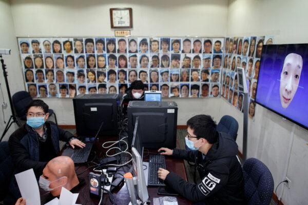 Software engineers work on a facial recognition program that identifies people when they wear a face mask at the development lab of the Chinese electronics manufacturer Hanwang (Hanvon) Technology in Beijing on March 6, 2020. (Thomas Peter/Reuters)