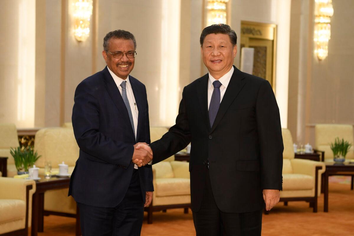 World Health Organization director general Tedros Adhanom (L) shakes hands with Chinese leader Xi Jinping before a meeting at the Great Hall of the People in Beijing on Jan. 28, 2020. (Naohiko Hatta/AFP via Getty Images)
