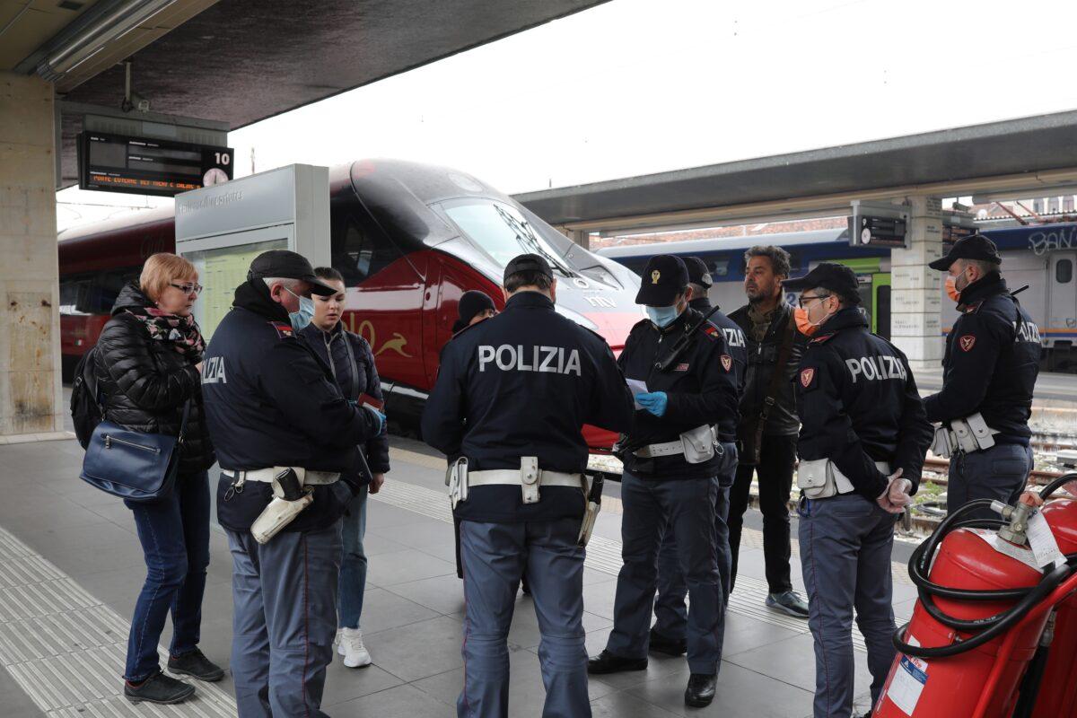 Police officers check citizens and tourists at the Venice Santa Lucia railway station in Venice, to make sure that they are not violating the quarantine, before they get on the trains to leave the city, in Italy on March 10, 2020. (Marco Di Lauro/Getty Images)