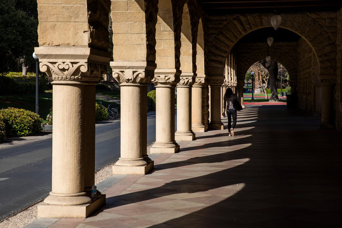 A person walks past archways during a quiet morning at Stanford University in Stanford, California, on March 9, 2020. (Philip Pacheco/Getty Images)