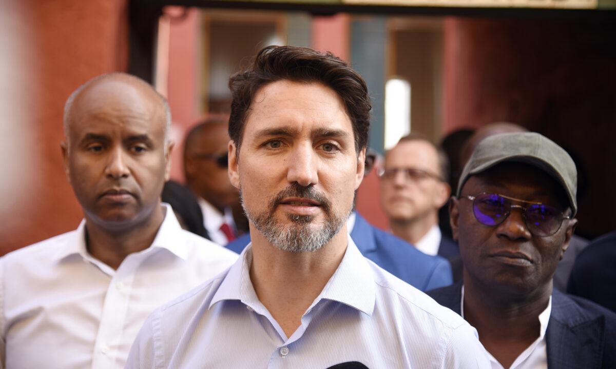 Canadian Prime Minister Justin Trudeau (C) walks with Abdoulaye Diop (R), the Minister of Culture and Communication of Senegal, and Ahmed Hussen (L), Canadian Member of Parliament upon his arrival on Goree Island off the coast of Dakar on Feb. 12, 2020. (Seyllou/AFP via Getty Images)