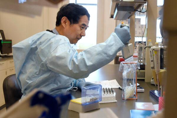 Microbiologist Xiugen Zhang runs a Polymerase Chain Reaction, or PCR, test at the Connecticut State Public Health Laboratory, in Rocky Hill, Conn., on March 2, 2020. (Jessica Hill/File/AP Photo)