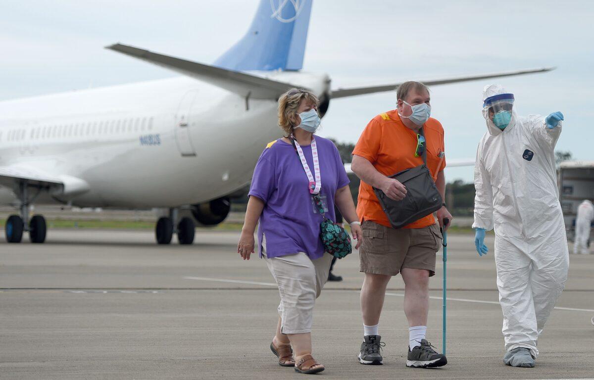 Medical personnel help load passengers from the Grand Princess cruise ship onto airplanes at Oakland International Airport in Oakland, Calif., on March 10, 2020. (Josh Edelson/AFP via Getty Images)