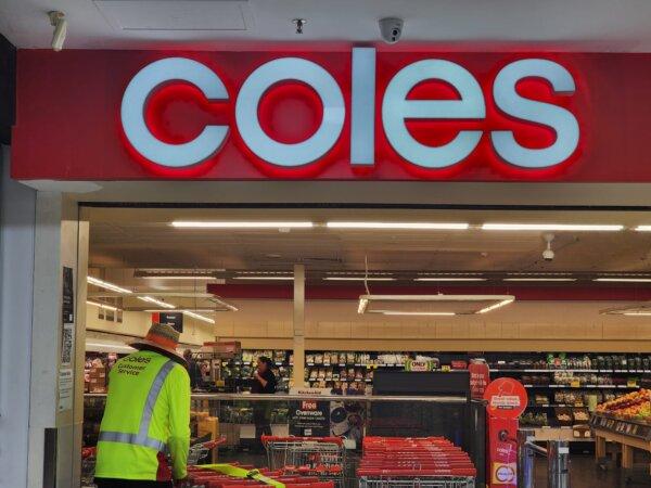 A man restocks trolleys at a Coles supermarket in Albany, Western Australia, on April 11, 2024. (Susan Mortimer/The Epoch Times)