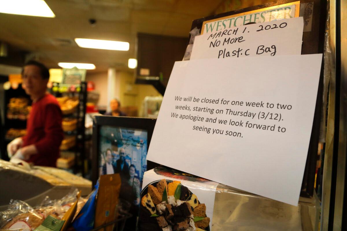 A notice hangs near the cash register at a bagel shop in New Rochelle, N.Y., on March 11, 2020. (Julie Jacobson/AP Photo)