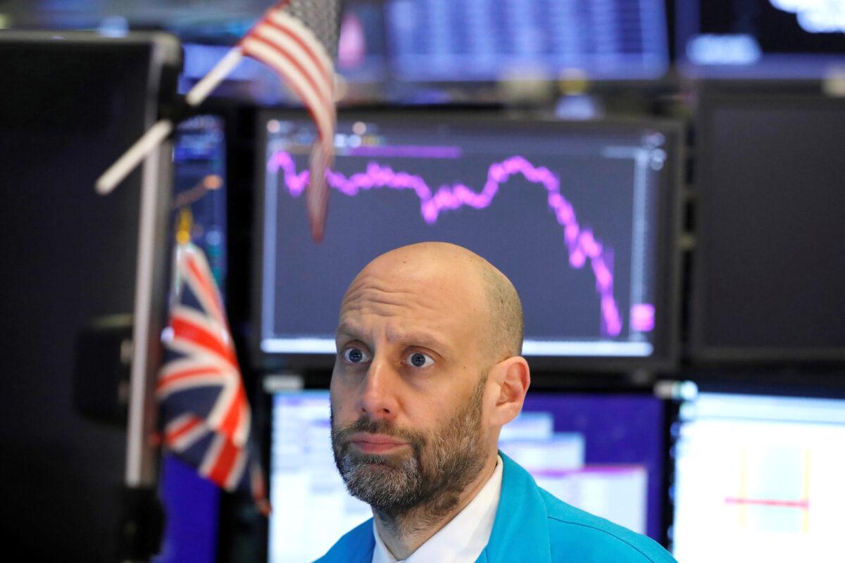 A trader works on the floor of the New York Stock Exchange in New York City on March 11, 2020. (Andrew Kelly/Reuters)