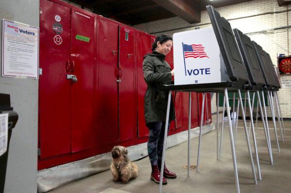 A voter Kasi Seguin casts her ballot in the Democratic primary election in Detroit, Michigan, on March 10, 2020. (Rebecca Cook/Reuters)
