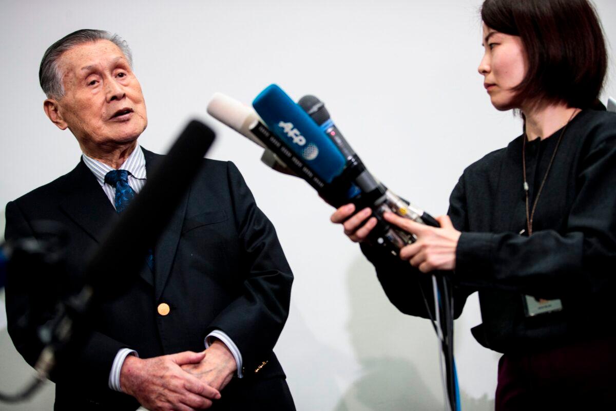 Tokyo 2020 president Yoshiro Mori (L) speaks to reporters during a press conference in Tokyo on March 11, 2020. (Behrouz Mehri/AFP via Getty Images)