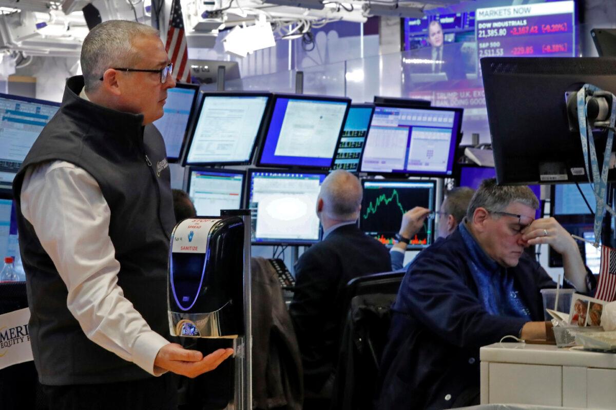 A trader on the floor of the New York Stock Exchange, on Wall Street, New York City, on March 12, 2020. (Richard Drew/AP Photo)