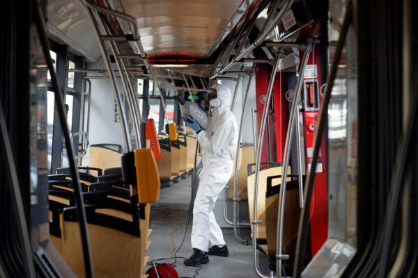 A worker in a protective suit disinfects a tram due to coronavirus disease (COVID-19) concerns in Prague, Czech Republic, on March 12, 2020. (David W Cerny/Reuters)