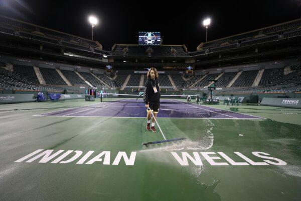 Courtmaster Jeffrey Brooker cleans the center court at the Indian Wells Tennis Garden in Indian Wells, Calif., on March 8, 2020. (Al Bello/Getty Images)