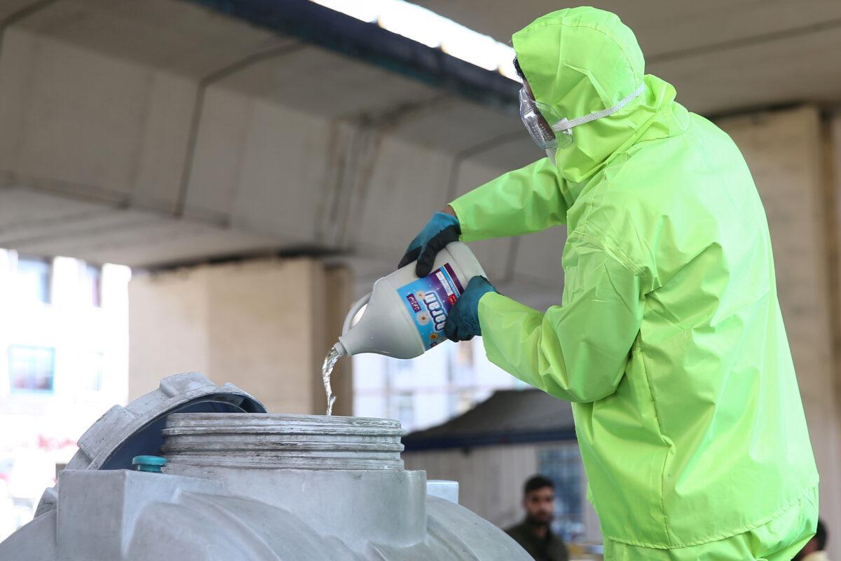 A member of a medical team wears a protective face mask, following the coronavirus outbreak, as he prepares disinfectant liquid to sanitise public places in Tehran, Iran in a March 5, 2020, file photograph. (WANA/Nazanin Tabatabaee via Reuters)