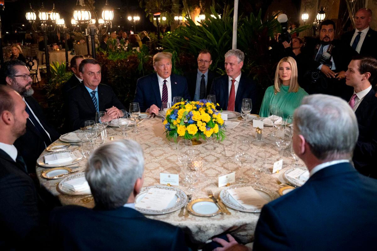 President Donald Trump, center, speaks with Brazilian President Jair Bolsonaro, left, during a dinner at Mar-a-Lago in Palm Beach, Florida, on March 7, 2020. (Jim Watson/AFP via Getty Images)