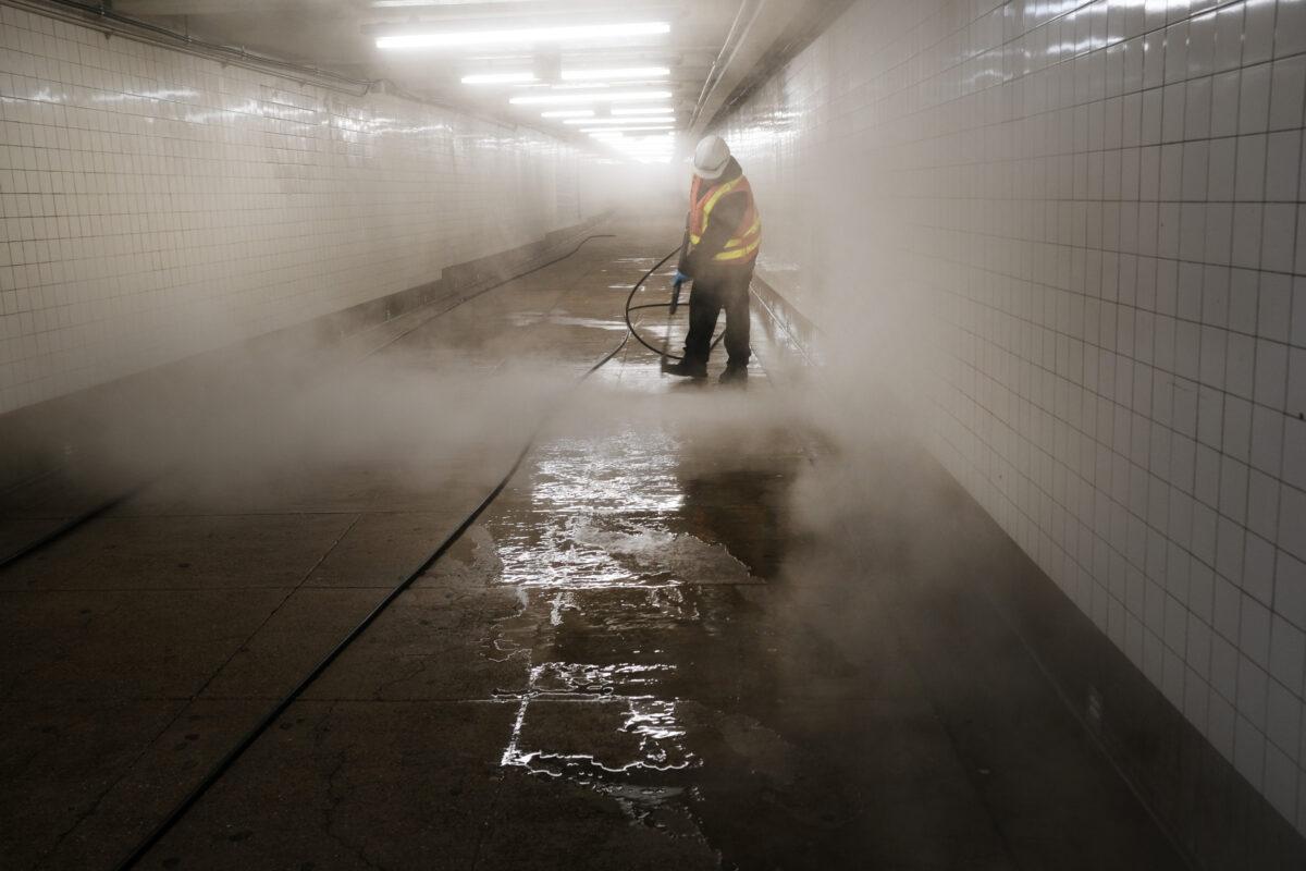 Workers clean a subway station in Brooklyn as New York City confronts the coronavirus outbreak on March 11, 2020. (Spencer Platt/Getty Images)