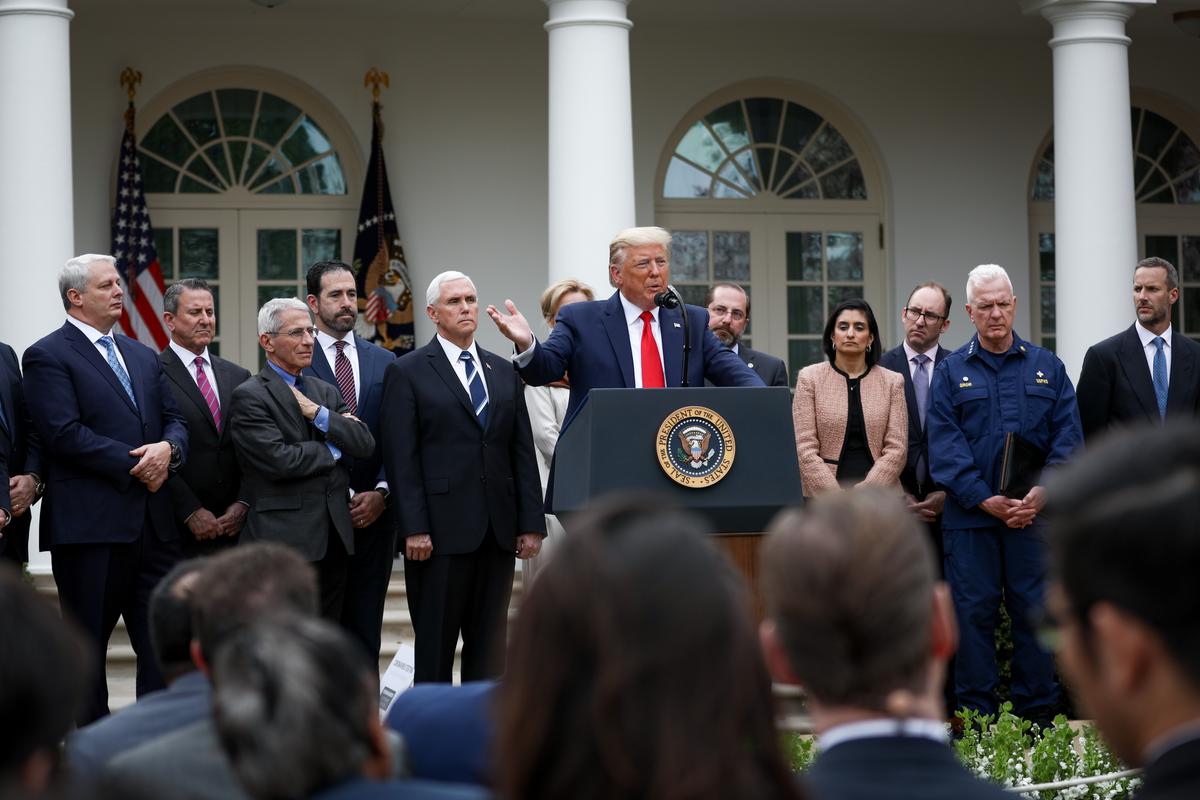 President Donald Trump, flanked by officials and business leaders, announces a national emergency with regard to the coronavirus in the White House Rose Garden in Washington on March 13, 2020. (Charlotte Cuthbertson/The Epoch Times)